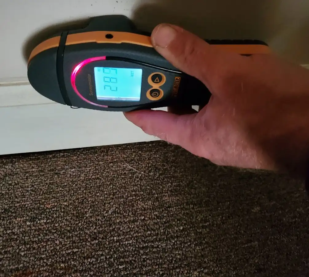 Moisture detection at baseboard during Storm Damage Restoration in North Hempstead